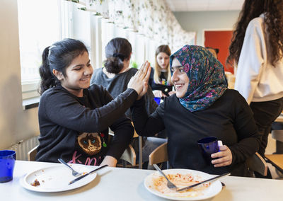 Smiling girls in school canteen