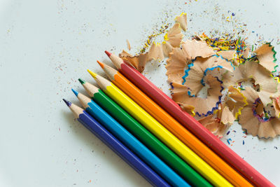 Close-up of colored pencils against white background