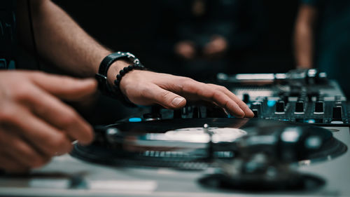 Midsection of man using turntable