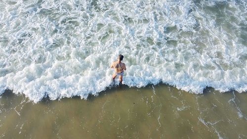 High angle view of man walking on beach