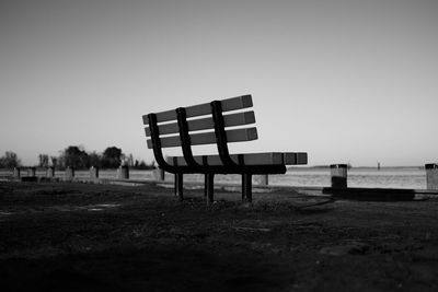 Empty seats on landscape against clear sky