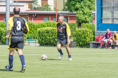 Full length of man playing soccer ball on field