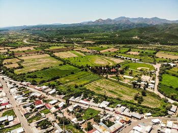 High angle view of agricultural field by houses