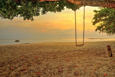 Scenic view of beach against sky during sunset