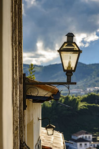 Low angle view of street light against building