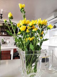 Close-up of yellow flower pot on table