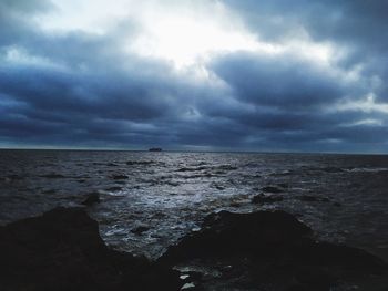 View of calm sea against cloudy sky