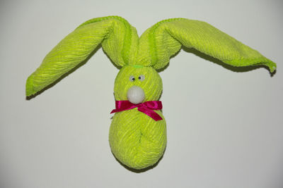 Close-up of green toy against white background