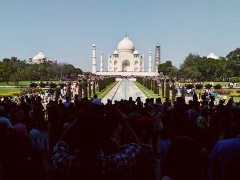 People at temple against clear sky