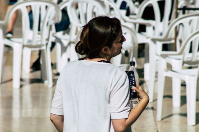 Rear view of woman looking at camera