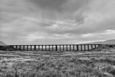 View of viaduct against cloudy sky