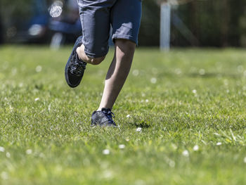 Low section of person playing on grass