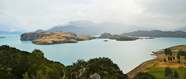 Scenic view of sea and mountains against sky