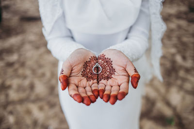 Close-up of hands holding ring