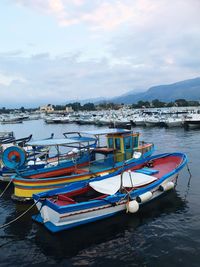 Boats moored on sea against sky