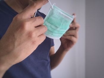 Midsection of man holding paper