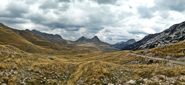 Scenic view of mountains against cloudy sky