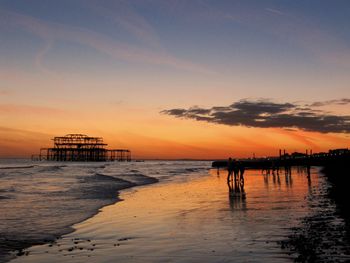 Silhouette pier on sea against sky during sunset