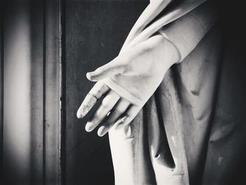 Close-up of hand touching leaf