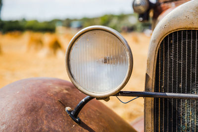 Close-up of rusty bicycle on field