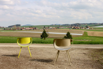 Empty chairs on field