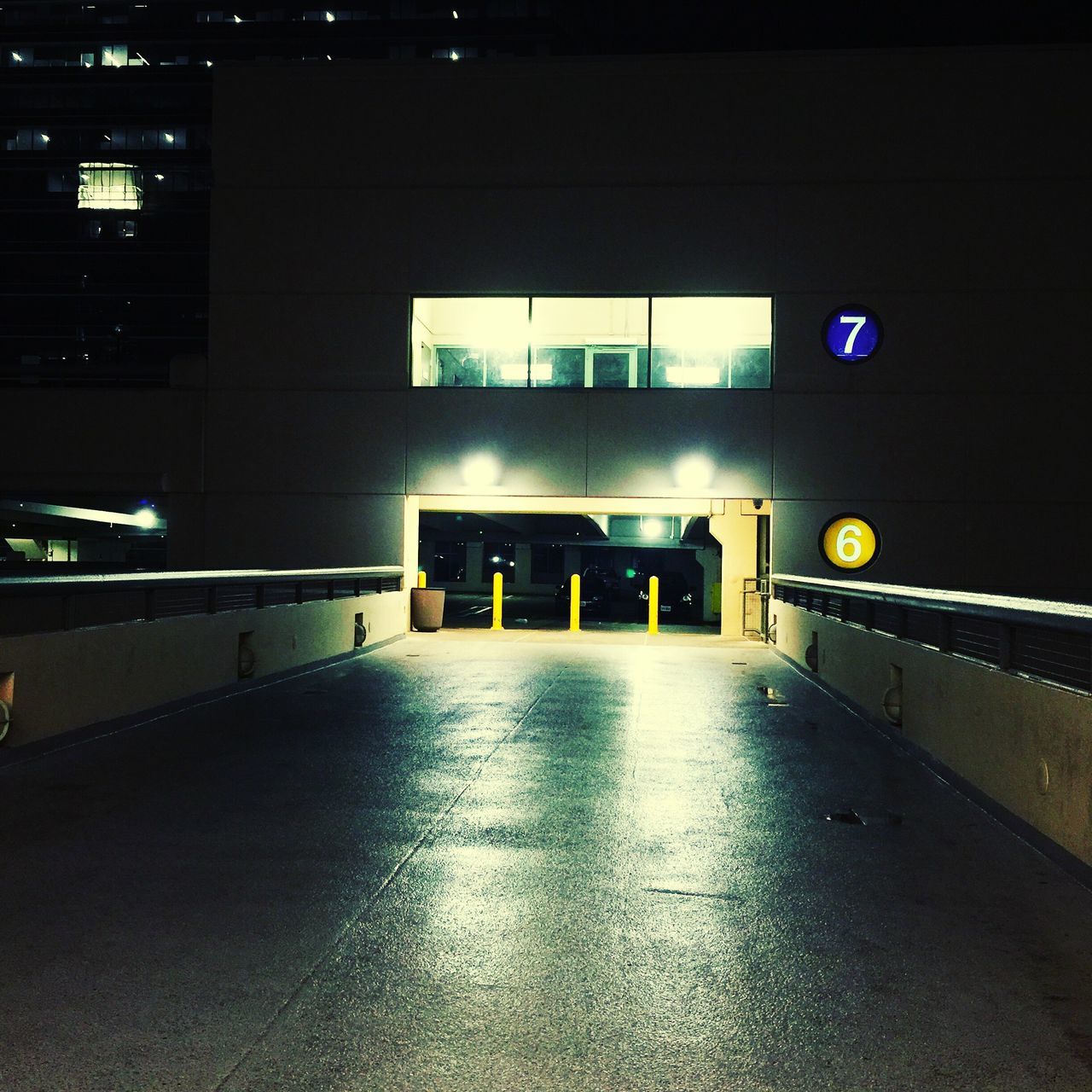 illuminated, night, architecture, built structure, indoors, building exterior, lighting equipment, empty, reflection, building, city, transportation, no people, the way forward, light - natural phenomenon, street, modern, dark, absence, flooring