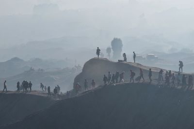 Group of people on foggy covered landscape