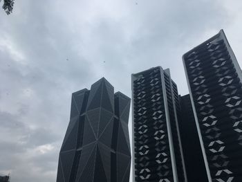 Low angle view of modern buildings against sky in city