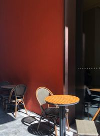 Empty chairs and tables at sidewalk cafe