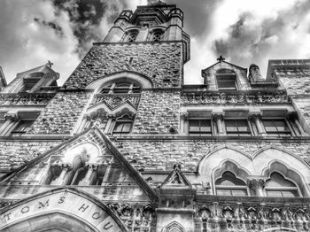 Low angle view of building against cloudy sky