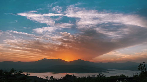 Scenic view of silhouette mountains against sky during sunset