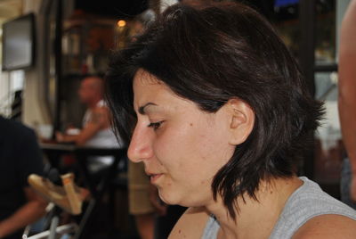 Profile view of woman sitting at outdoor cafe