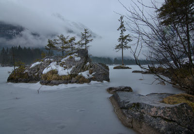 Scenic view of snow covered land against sky