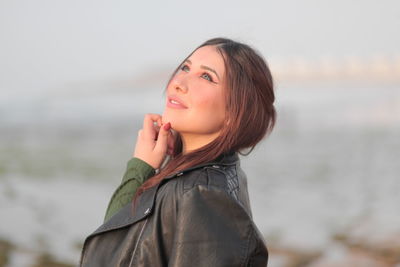Portrait of smiling young woman standing outdoors