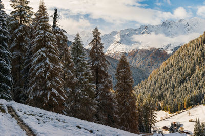 Panoramic view of snow covered mountains against sky