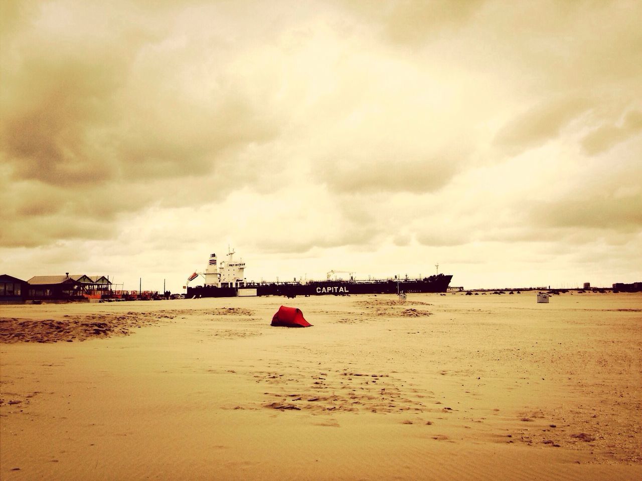 beach, sand, sky, cloud - sky, cloudy, shore, sea, cloud, tranquility, scenics, tranquil scene, nature, overcast, beauty in nature, horizon over water, incidental people, weather, transportation, outdoors, water