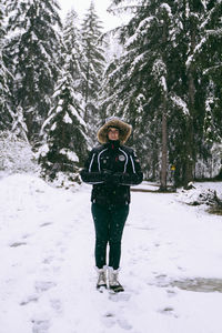 Portrait of woman standing on snow