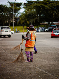 Rear view of woman walking on road