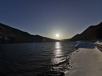 Scenic view of sea against clear sky during sunset