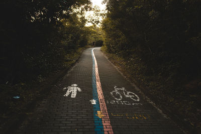 Road sign amidst trees