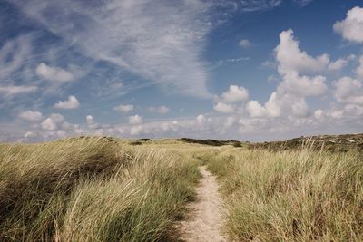 Scenic view of dunes against sky