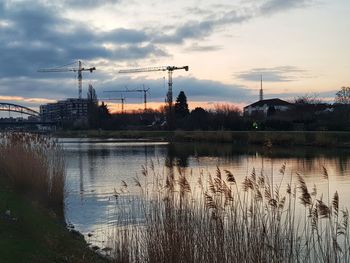 Scenic view of lake against sky at sunset