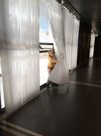 Woman standing in corridor of building