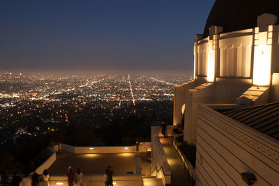 High angle view of illuminated buildings in city at night