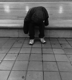 Low section of people standing on tiled floor