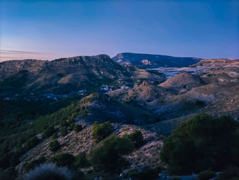 Scenic view of mountains against clear blue sky