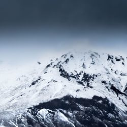 Scenic view of snow covered mountains against sky