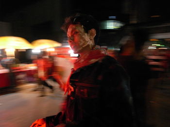 Blurred motion of woman at night