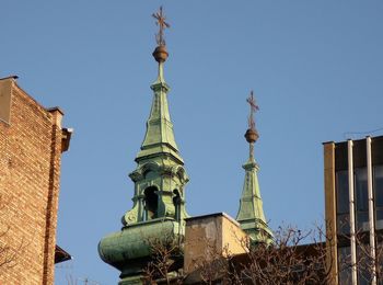 Low angle view of buildings against clear blue sky