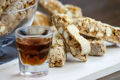 Alcoholic beverage in a shot glass close to homemade cake